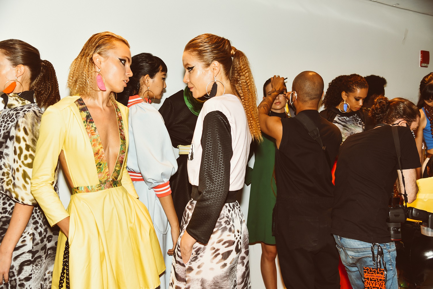 Model in Zuri Perle Iboju mask Earrings backstage at new york fashion week runway accessories